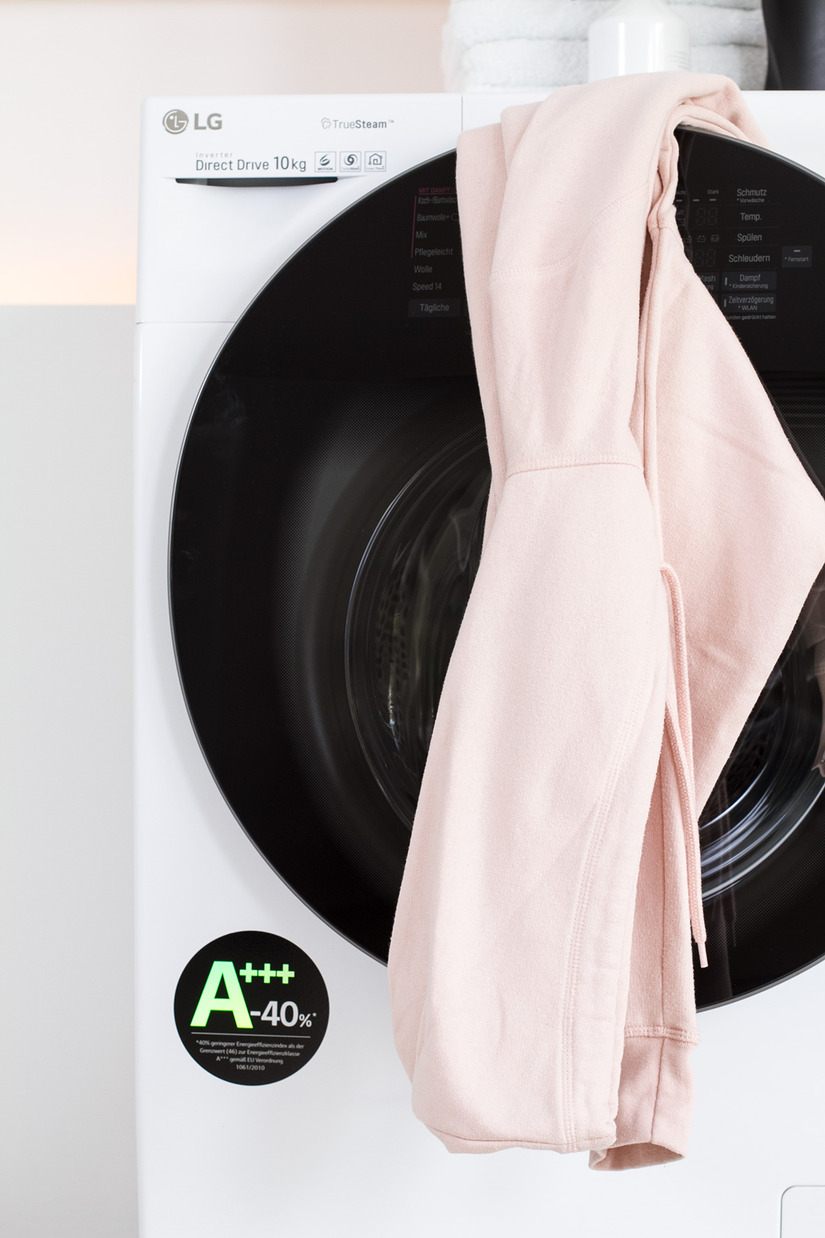 laundry, pink sweater hanging on washer, picture from LG TwinWash washer blog post on lifetime-pieces.com