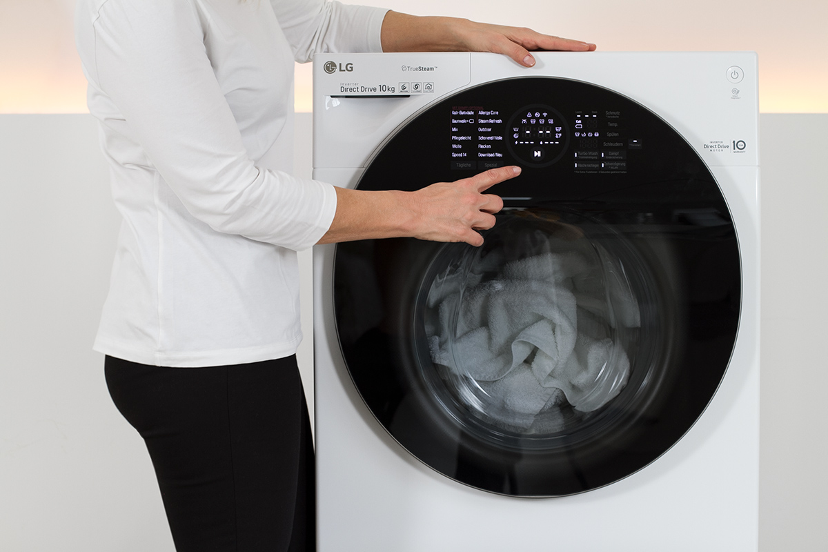 women starting a washing machine, washer, picture from LG TwinWash blog post on lifetime-pieces.com