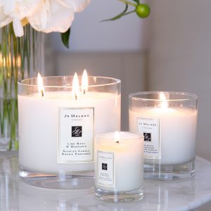 Jo Malone London, living in a scented home, three scented candles, a vase with white peonies flowers on the table